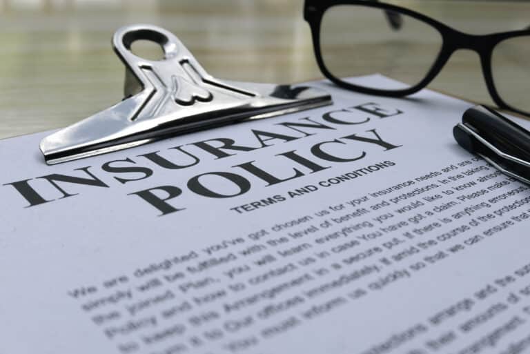 Insurance policy and terms on a wooden surface