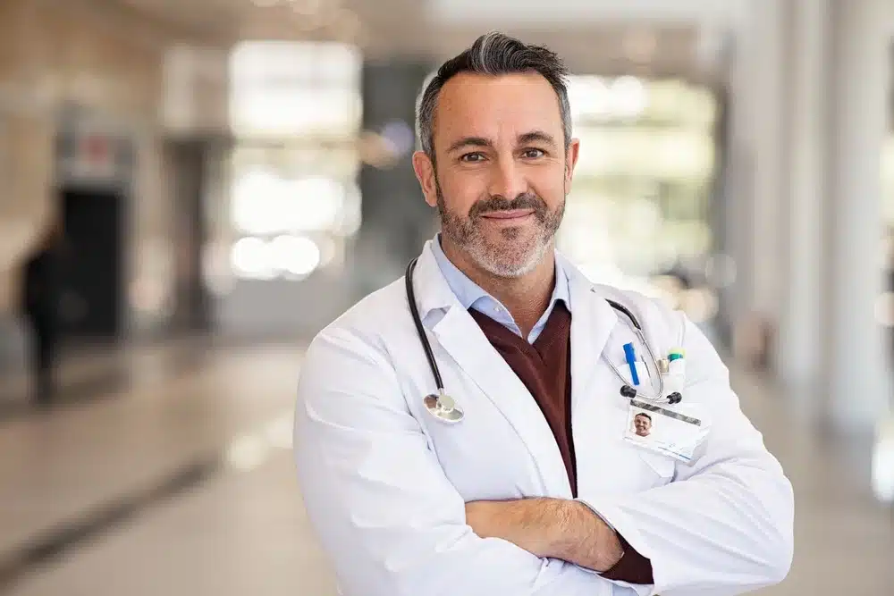 Happy, smiling male physician in a modern hospital setting