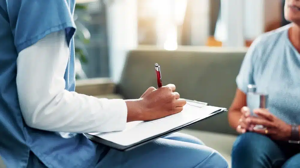 Nurse taking notes for a patient