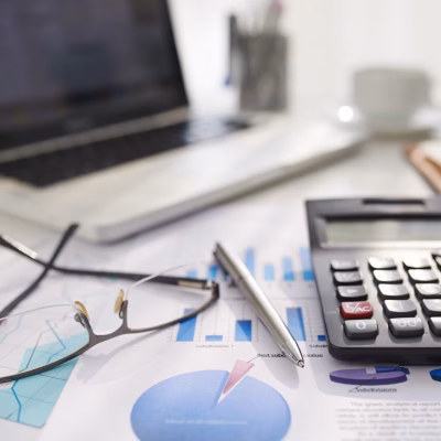 Business document, calculator and glasses on table of entrepreneur