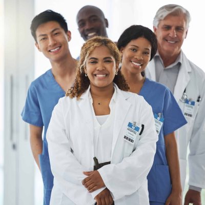 Portrait of a group of medical practitioners standing together in a hospital.