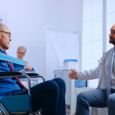 Recovery program for invalid senior persons, training with elastic band under doctor supervision in private recovery facility. Invalid physiotherapy program, health care injury rehabilitation in hospital or clinic